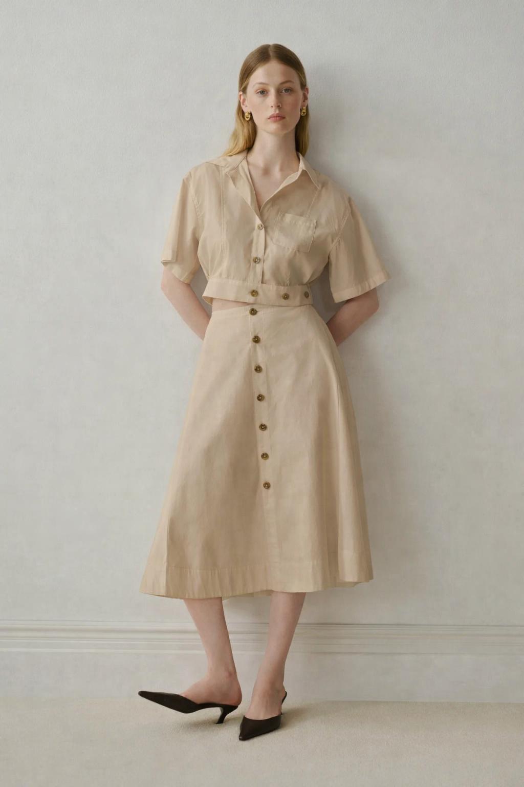 Beige button-front shirt dress with black pointed heels
